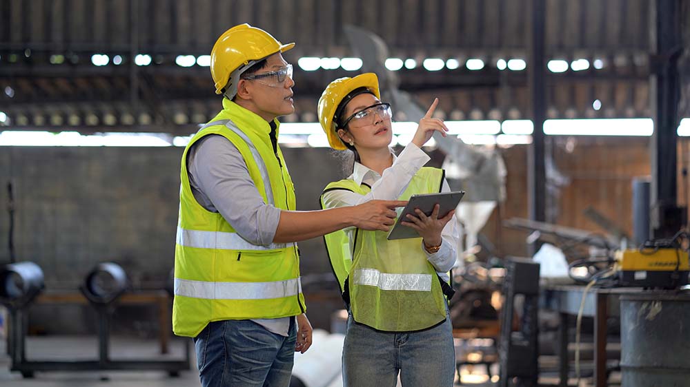two managers overlooking safety in the factory