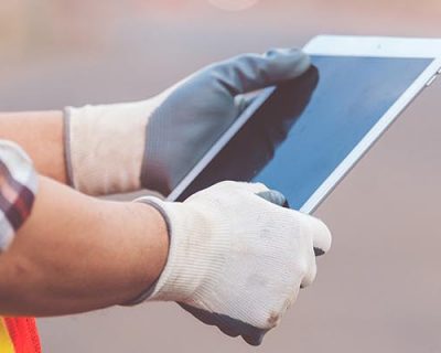 spanish worker using a tablet while working or taking spanish safety training