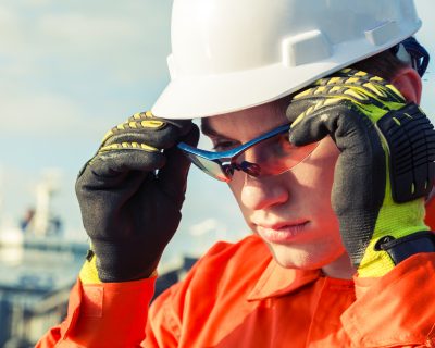 Orange robe engineer is wearing the safety goggles.