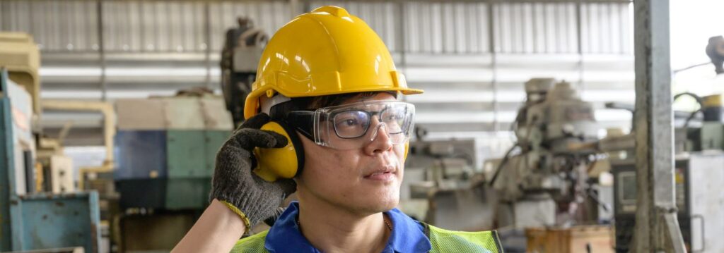 Male asian inspector, engineer testing ear muff in the production line process in factory