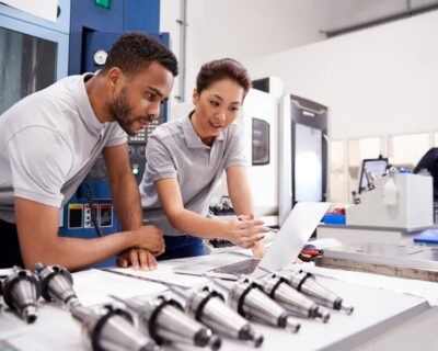 Two Engineers Using EHS management Software On Laptop