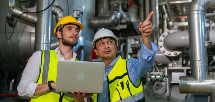 Two Employees point out things that require a corrective action plan in an energy refining plant. 