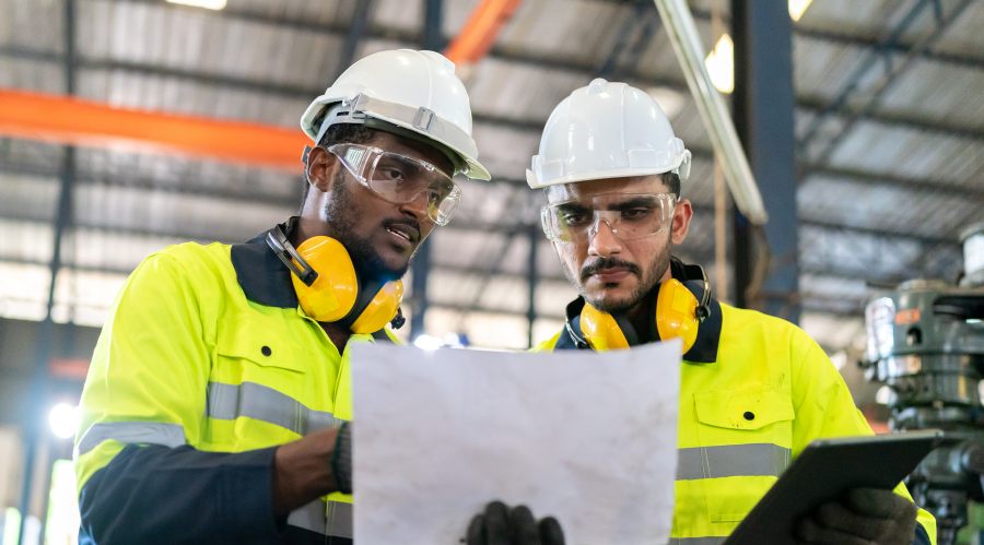 professional technician engineer with safety helmet hard hat working in industrial manufacturing factory, men at work to checking LMS