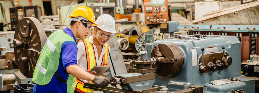 Mix race worker working together help each other to work in heavy industry machine wearing safty suit in factory production line.engineer coworking with staff.