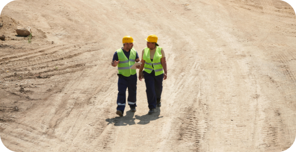 Two construction workers reviewing a construction site.