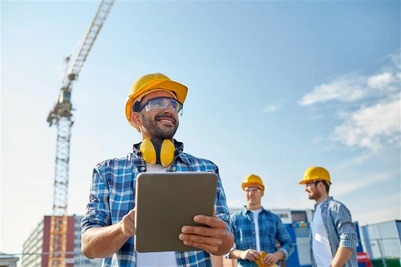 Worker entering data into a tablet, representing insight-driven audit tools that go beyond basic compliance checks.