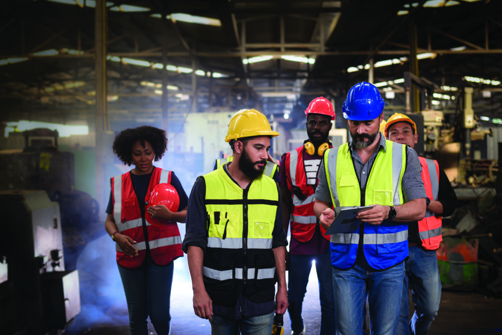 Colleagues analyzing safety performance data reflecting how U.S. companies use integrated platforms for real-time safety training. 