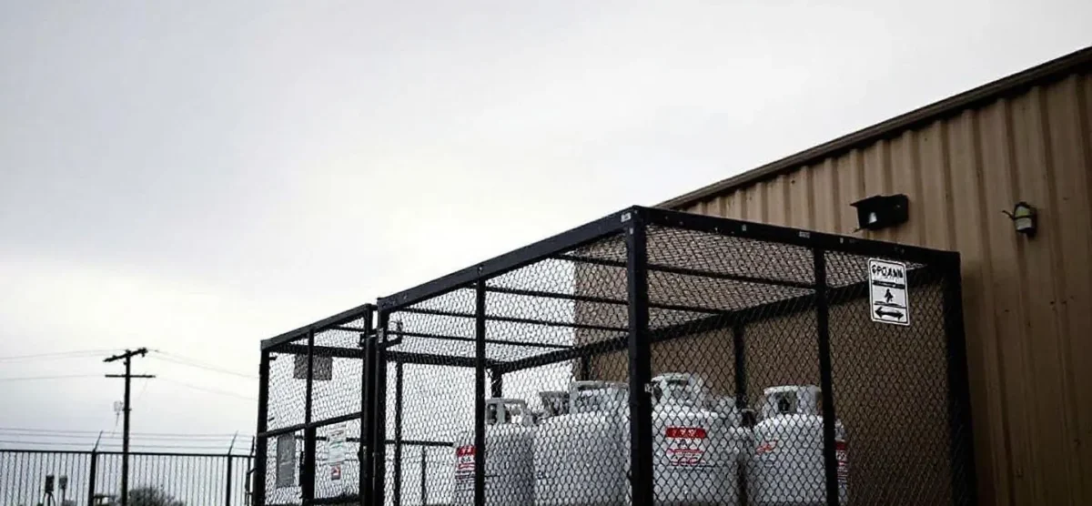 Propane tank in an open area, highlighting risks of improper handling on worksites.