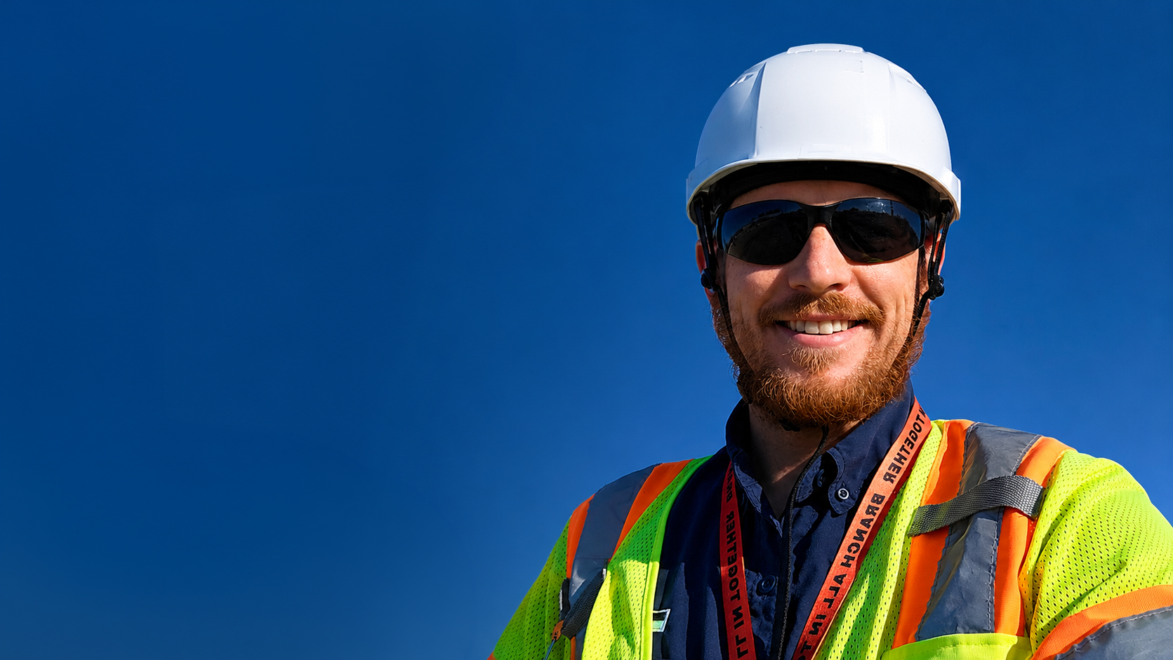 Construction safety manager speaking with workers about building a stronger job site safety culture.